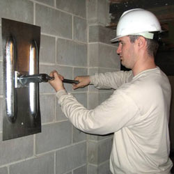 installing a wall anchor to repair an bowing foundation wall in Gainesville