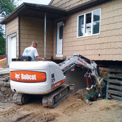 Excavating to expose the foundation walls and footings for a replacement job in Newnan